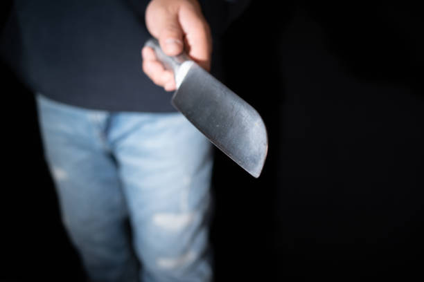 istock Murder, Man holding a knife in his hand.Hand holding a kitchen knife, ready to stab. 2189216262