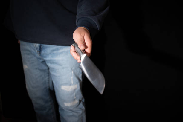istock Murder, Man holding a knife in his hand.Hand holding a kitchen knife, ready to stab. 2189216276