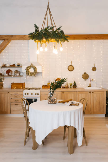istock Kitchen with a round table and chairs, a white tablecloth and a Christmas wreath on the wall 2189217503