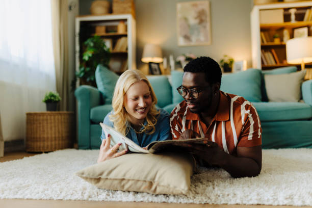 istock Young couple reading magazines. They are talking and sharing some laughs 2189218548