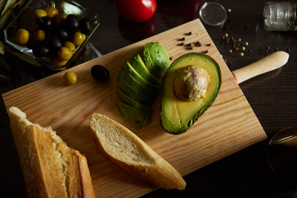 istock Fresh avocado and bread on a wooden cutting board with olives 2189218804