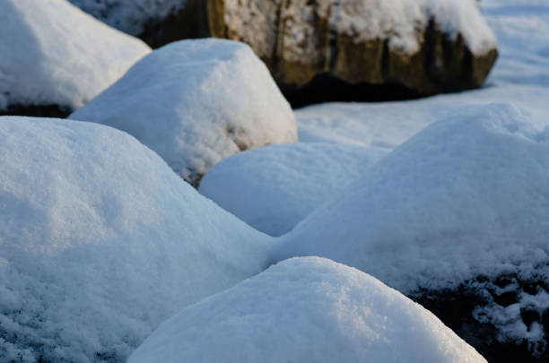 Triangle shaped sandstone rock covered in snow in the winter.