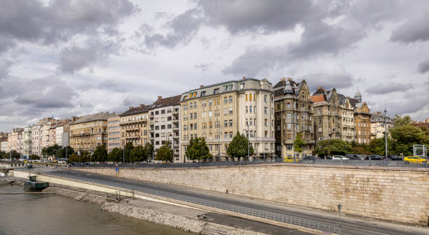 Panoramic view of Budapest, Hungary, taken from the Freedom Bridge, offering a stunning perspective of the city’s iconic landmarks along the Danube River. The image highlights the blend of historic and modern architecture, showcasing Budapest’s rich cultural heritage and its picturesque waterfront.