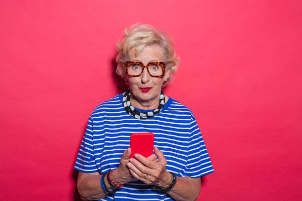 istock Portrait of surprised cool senior lady using mobile phone 2189228069