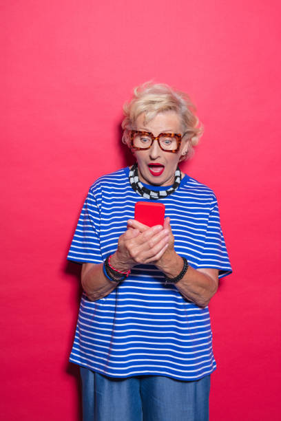 istock Portrait of surprised cool senior lady using mobile phone 2189228087