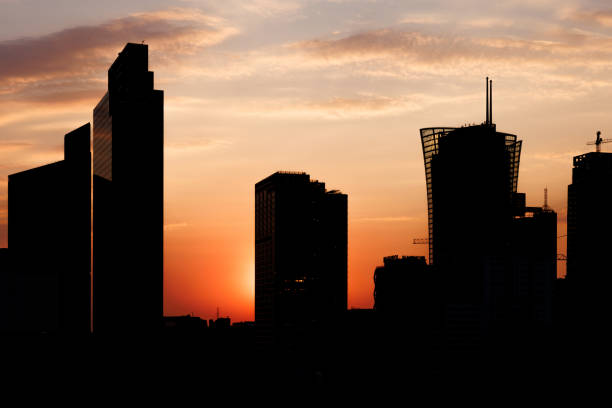 istock A skyline skyscrapers silhouette against a colorful sunset. 2189228098