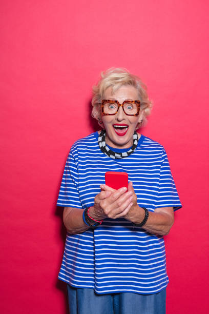 istock Portrait of surprised cool senior lady using mobile phone 2189228155