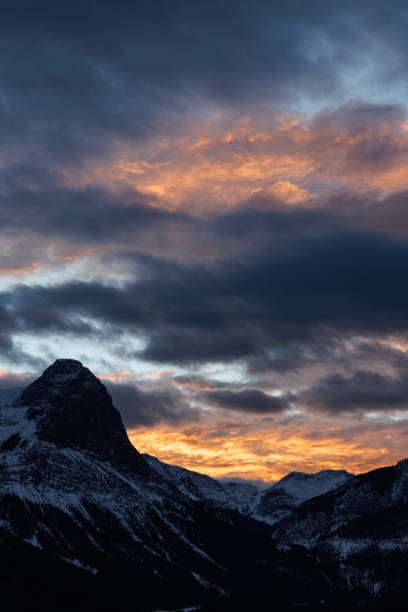 A view of Ha Ling Peak above Canmore, Alberta, Canada, at sunset. Ha Ling Peak is one of the iconic mountains near Canmore and stands at 7,897 feet.