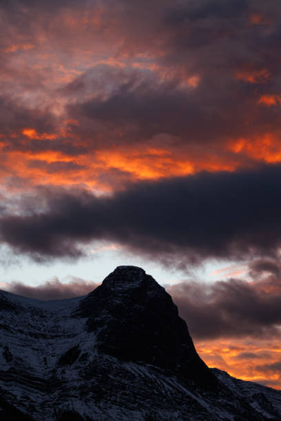 A view of Ha Ling Peak above Canmore, Alberta, Canada, at sunset. Ha Ling Peak is one of the iconic mountains near Canmore and stands at 7,897 feet.