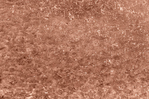 Rain splashing on water. Rainy Mocha brown background for design. Selective focus, defocus. Demonstrating color of 2025 year
