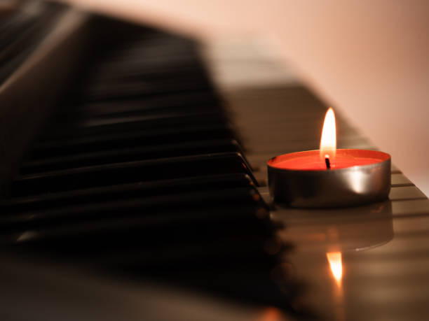 istock Candles with piano organ musical instrument background 2189231934