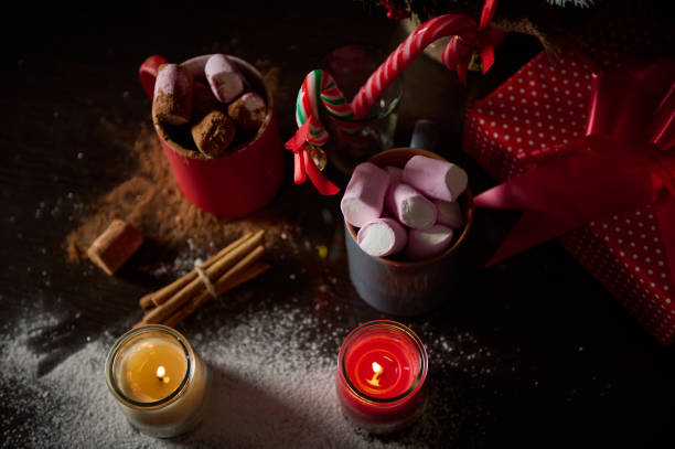 istock Cozy Christmas setting with hot cocoa, marshmallows, and festive decorations 2189232165