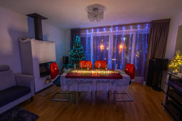 istock Christmas-themed dining area with decorated table, glowing candles, Christmas tree, and festive lighting for cozy holiday celebration. Sweden. 2189239280
