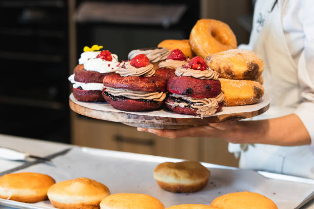 istock Crop woman with Berliners on tray in bakery 2189239847