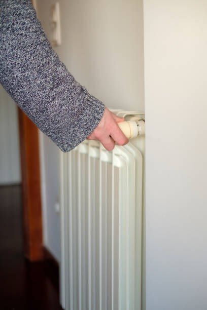 istock Man turning on the heating in the house 2189240194