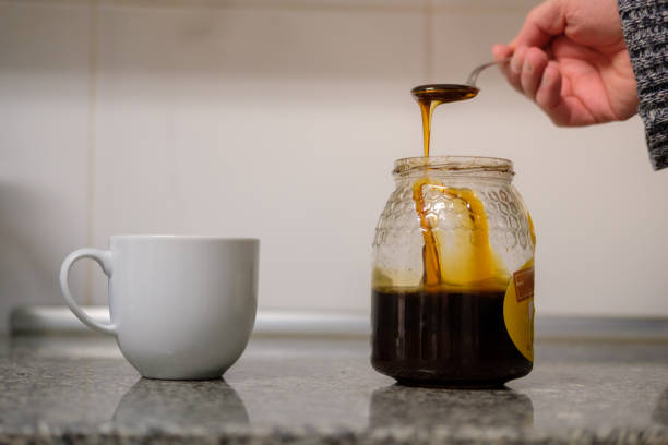 istock Man putting honey in milk or coffe 2189240320