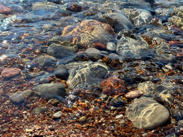 Sea clean water with stones and pebbles at the bottom.
