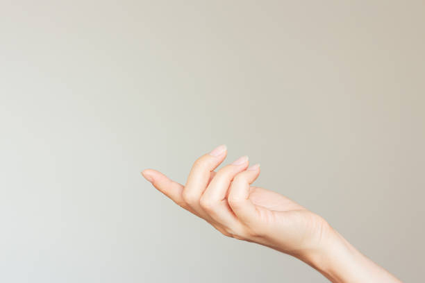 istock A woman's hand holding something on the pad of her index finger. Mockup. Empty space. 2189244490