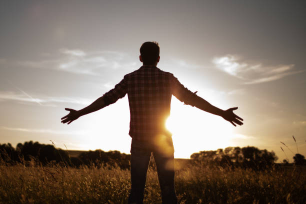 istock Men feeling free and accomplished in beautiful natural sunset settings. 2189245945