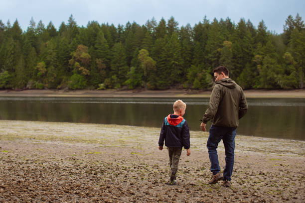 istock Father and son walking on the beach at fall season.  Washington state. 2189246022