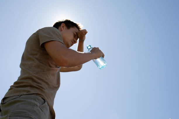 istock Men drinking water on a hot summer day. Stay hydrated. 2189246039