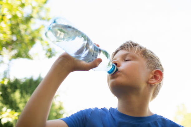 istock Little boy drinking water from a bottle. Stying hydrated on a hot summer day. 2189246065