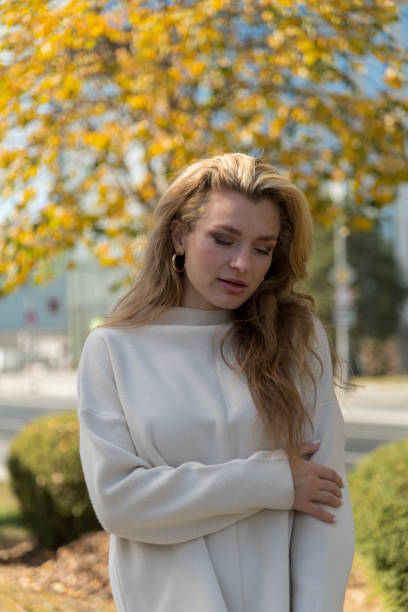 istock Beautiful woman by autumn coloured tree 2189249963