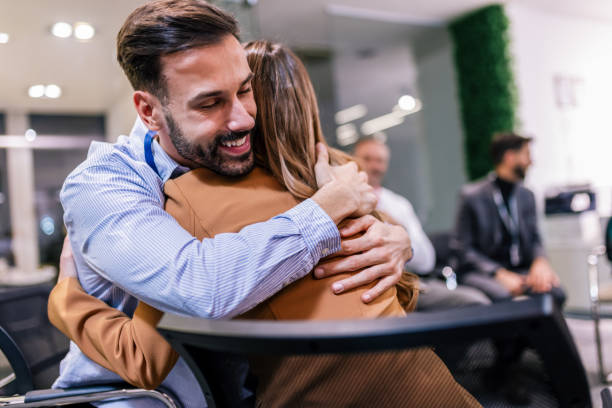 istock Business partners hugging on a group psychotherapy. 2189252287