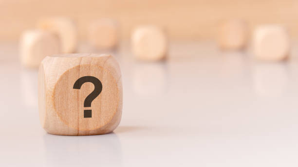 istock A wooden block with a question mark on a minimal background creates intrigue and prompts thought 2189255187