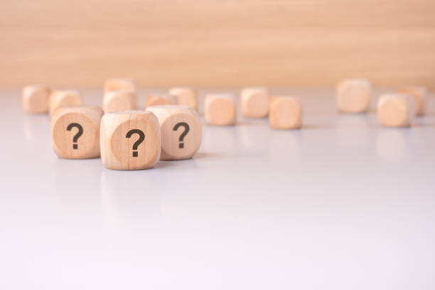istock On the table sits a collection of mysterious wooden blocks adorned with question marks 2189255279