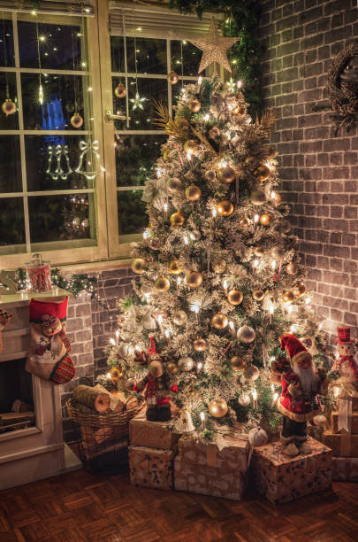istock Decorated Christmas tree near fireplace at home 2189255521