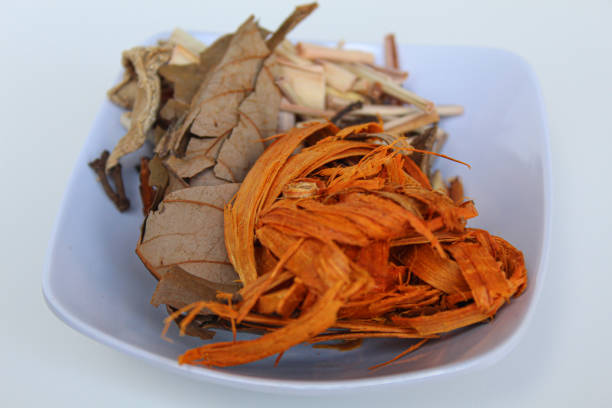 Wedang Uwuh, or Javanese herbal drink, isolated on white background. Ingredients before brewed of Indian redwood, dried ginger, lemongrass and cardamom