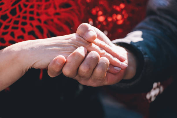 istock Two people hold hands in a intimate moment 2189259747