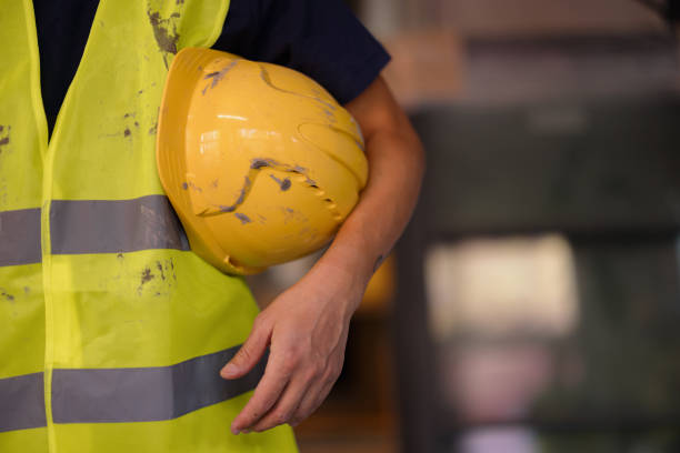istock Construction Worker Holding Hard Hat and Wearing Safety Vest 2189260207