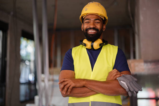 istock Smiling Construction Worker in Safety Gear at Building Site 2189260224