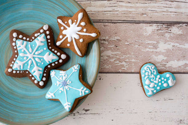 Different Christmas gingerbread cookies on rustic wooden background, top view. Space for text
