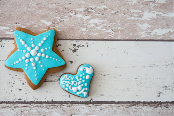 Different Christmas gingerbread cookies on rustic wooden background, top view. Space for text stock photo