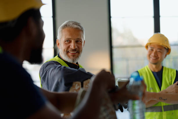 istock Group of Construction Workers Taking a Break on Job Site 2189260370