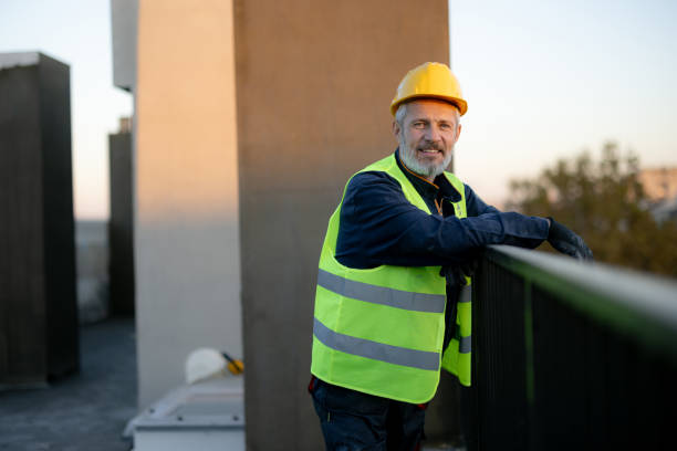 istock Smiling Construction Worker in Safety Gear on Building Site 2189260374