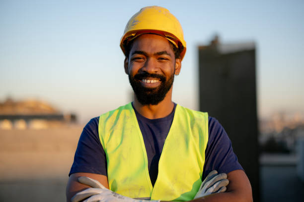 istock Confident Construction Worker Smiling in Hard Hat and Safety Vest 2189260380