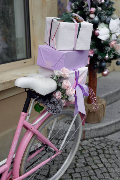istock A vintage pink bicycle with a basket filled with a Christmas tree 2189266690