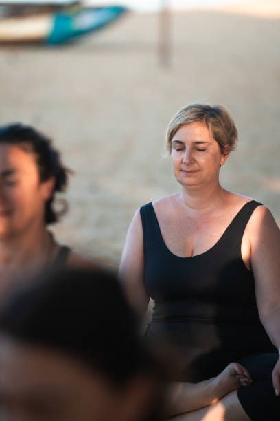 istock Woman meditating during yoga class on sri lankan beach 2189267890