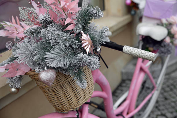 istock A vintage pink bicycle with a basket filled with a Christmas tree 2189268604