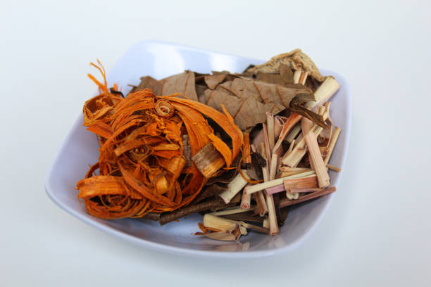 Wedang Uwuh, or Javanese herbal drink, isolated on white background. Ingredients before brewed of Indian redwood, dried ginger, lemongrass and cardamom