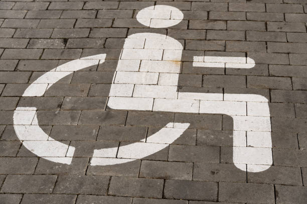 istock Pavement features a clear white symbol indicating a designated parking space for individuals with disabilities 2189270338
