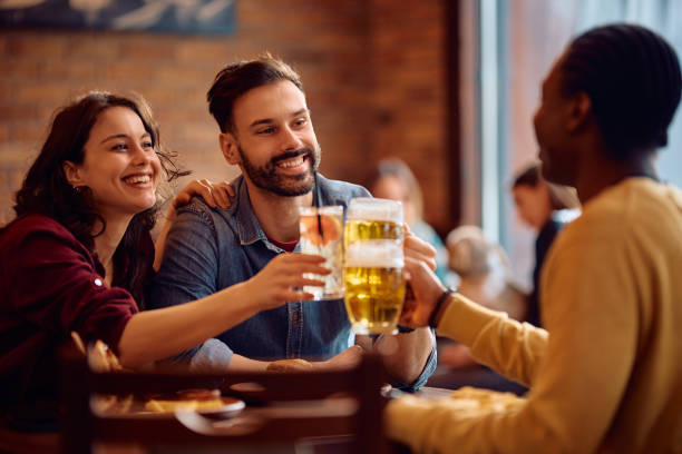 istock Cheerful friends toasting with drinks while gathering in a pub. 2189273720