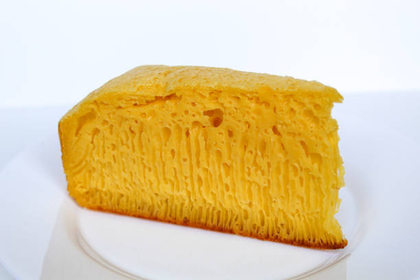 Bika ambon, traditional cake from Medan, Indonesia. Made from as tapioca flour, eggs, sugar, yeast and coconut milk. On white plate, isolated on white background