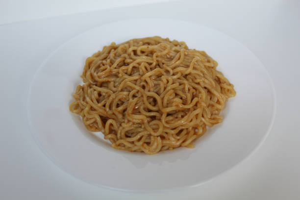 istock A serving of fried instant noodles, on white plate, isolated on white background 2189274683