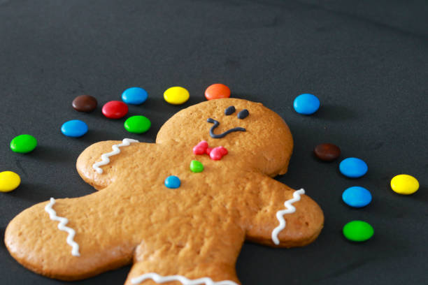 istock Gingerbread cookie surrounded by sprinkles on a black background 2189275212