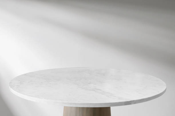 istock Round marble table top with abstract shadow drop on white wall background for mockup product display 2189278484